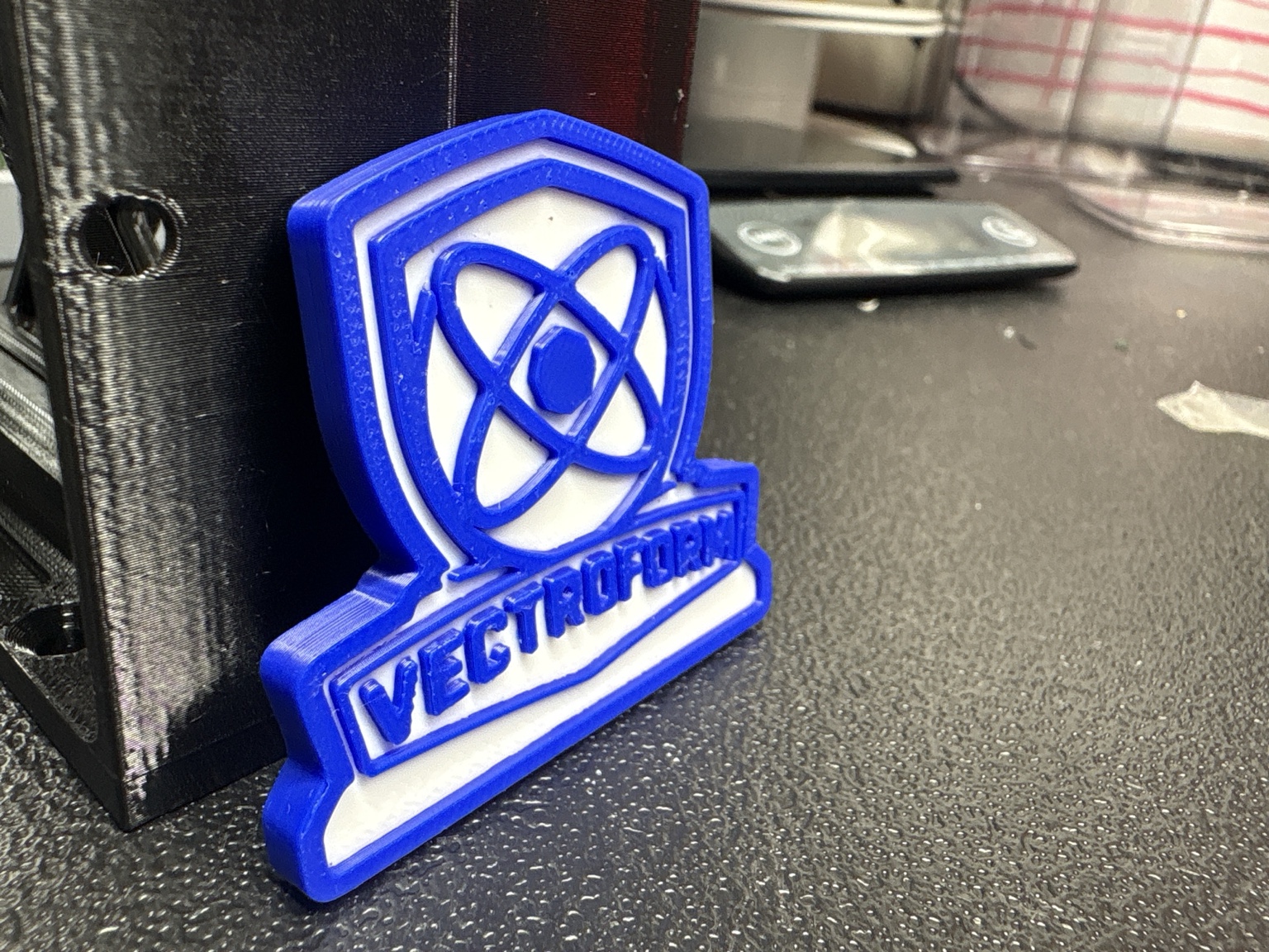 Original workshop photograph of the Vectroform 3D-printed emblem